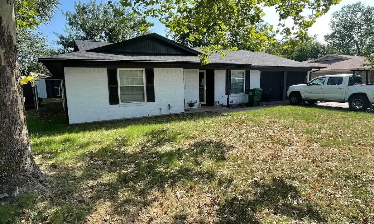 Professional roofing crew working on a residential roof in Keyes